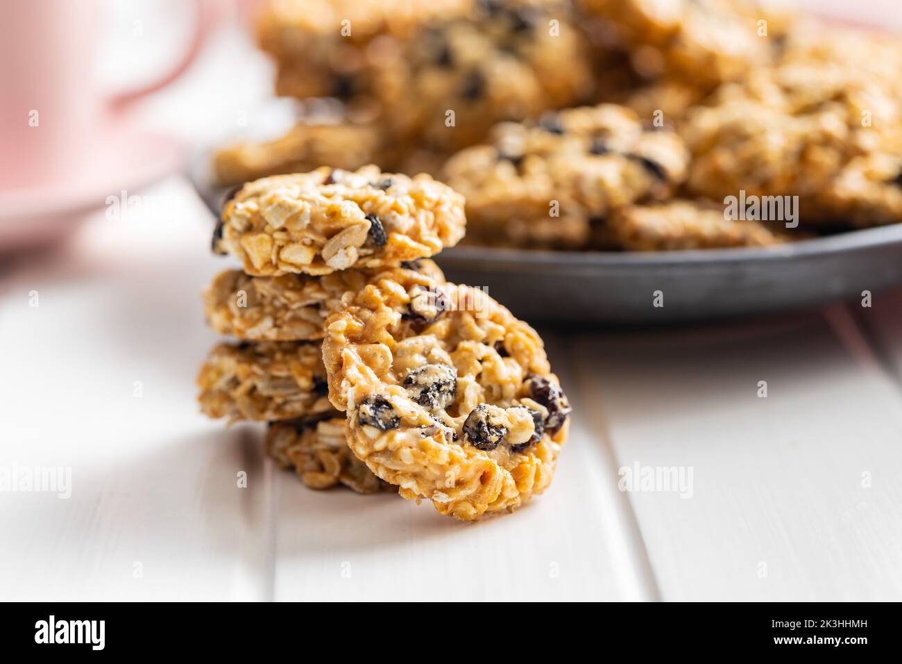 Wholegrain oat cookies. Cookies with oatmeal and raisins on the white table. Stock Photo