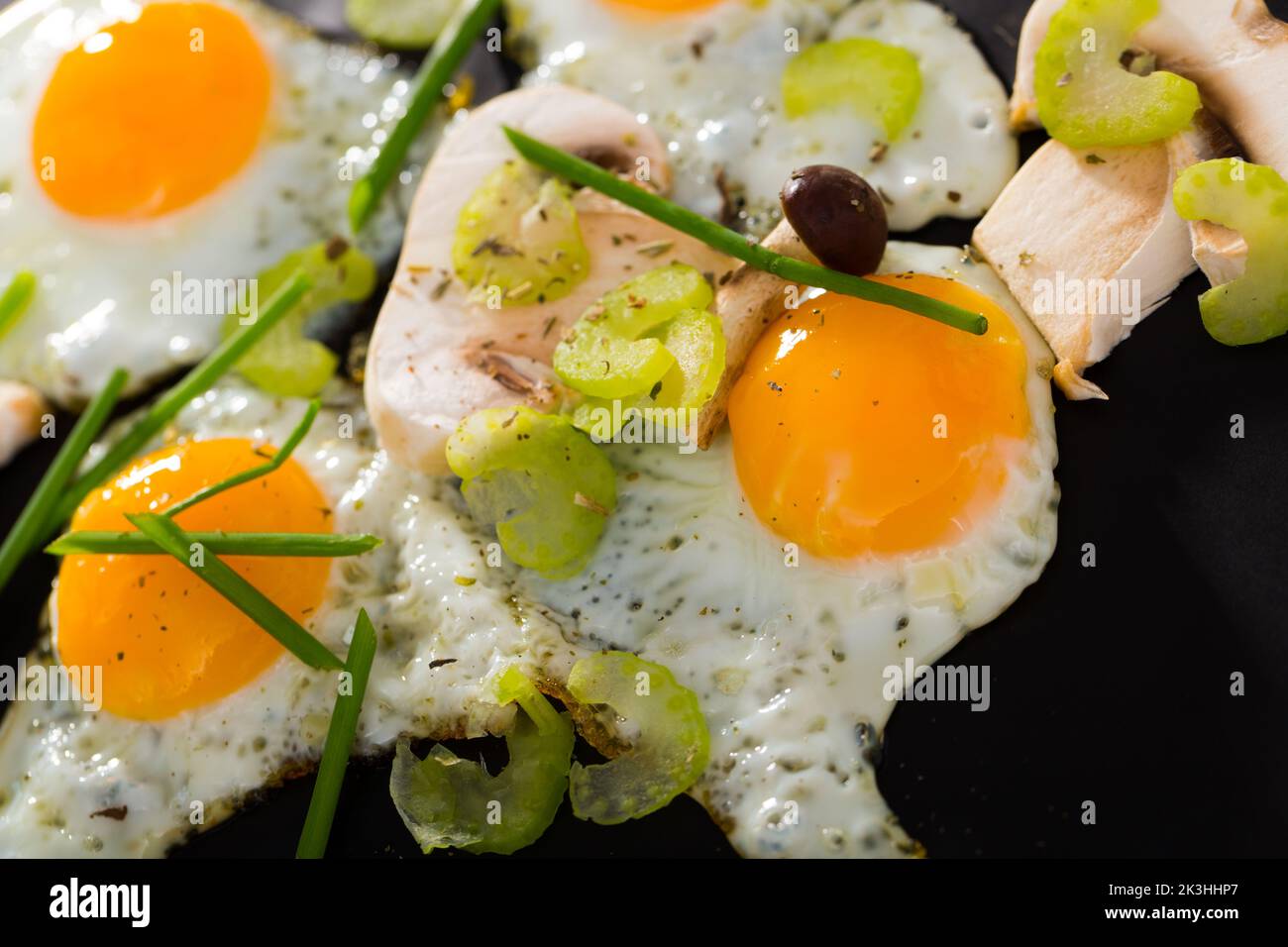 Fried quail eggs with champignons Stock Photo