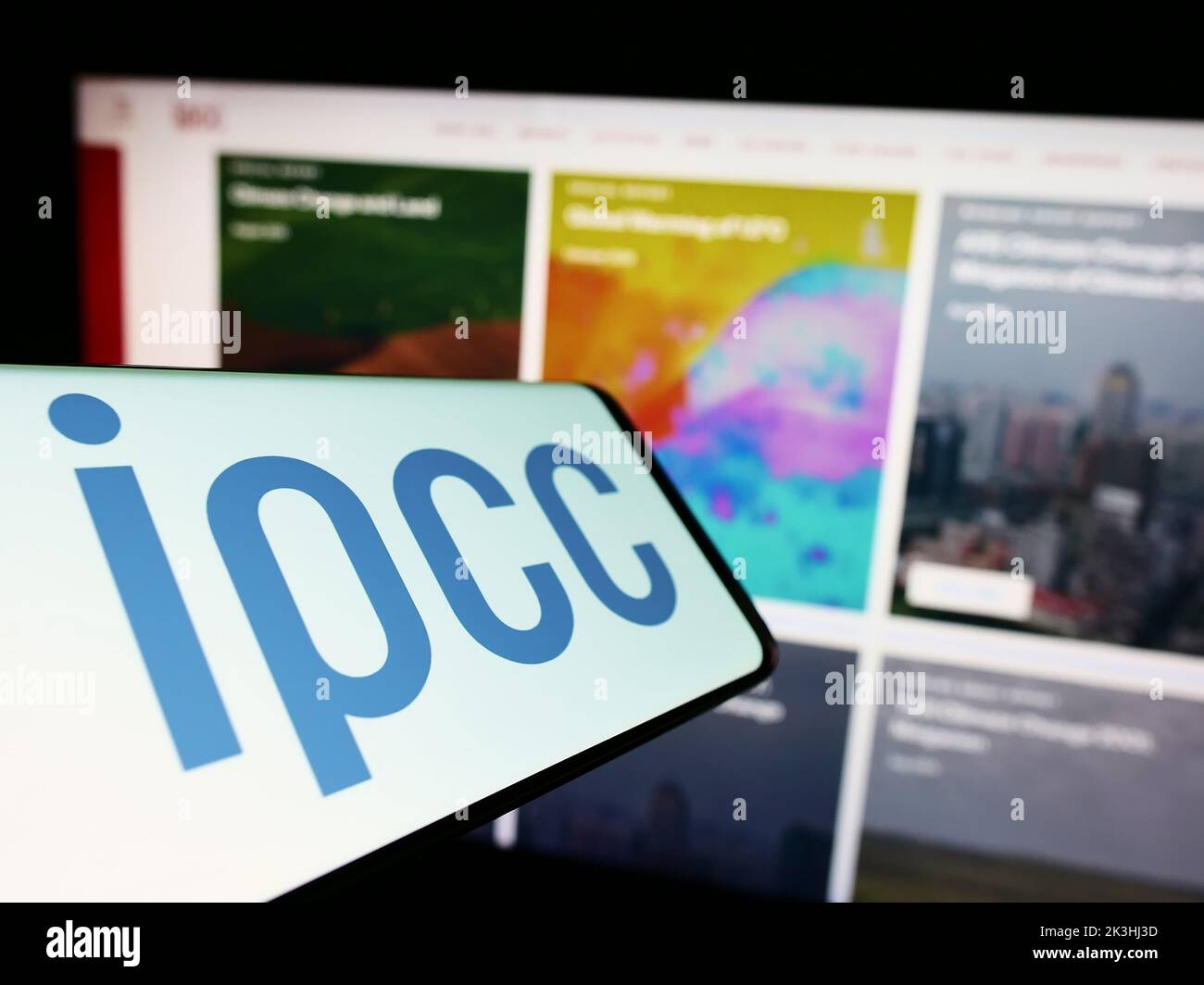Smartphone with logo of Intergovernmental Panel on Climate Change (IPCC) on screen in front of website. Focus on center of phone display. Stock Photo