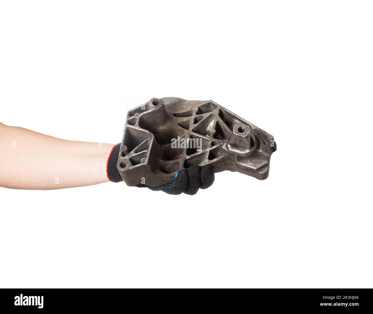 Aluminum engine cushion in the hand of a car mechanic on a white