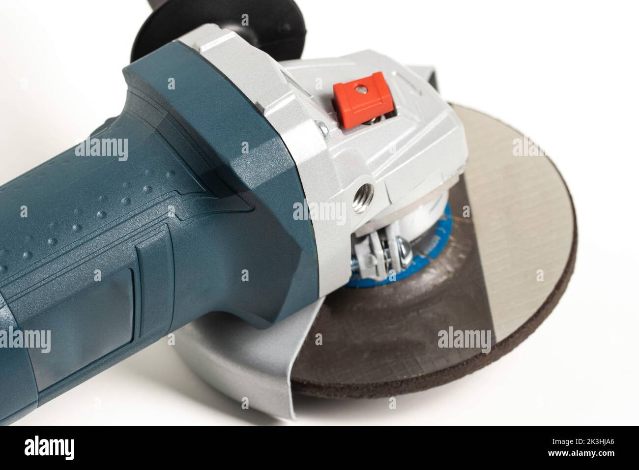 Modern angle grinder with red spindle lock button. Close-up. Vibration damping system Stock Photo