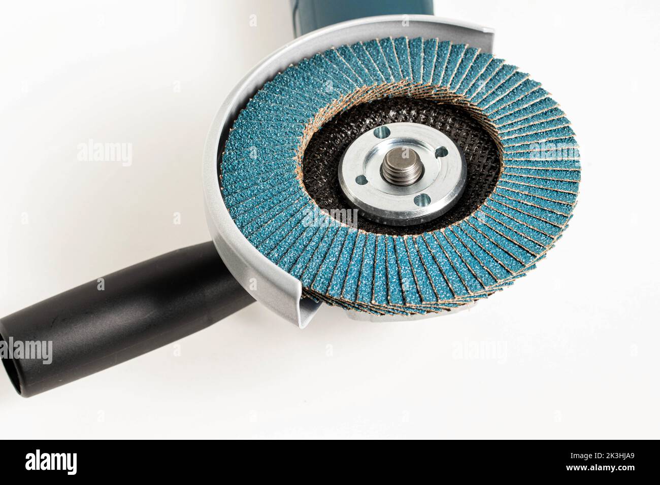 Modern professional angle grinder with a flap wheel on a white