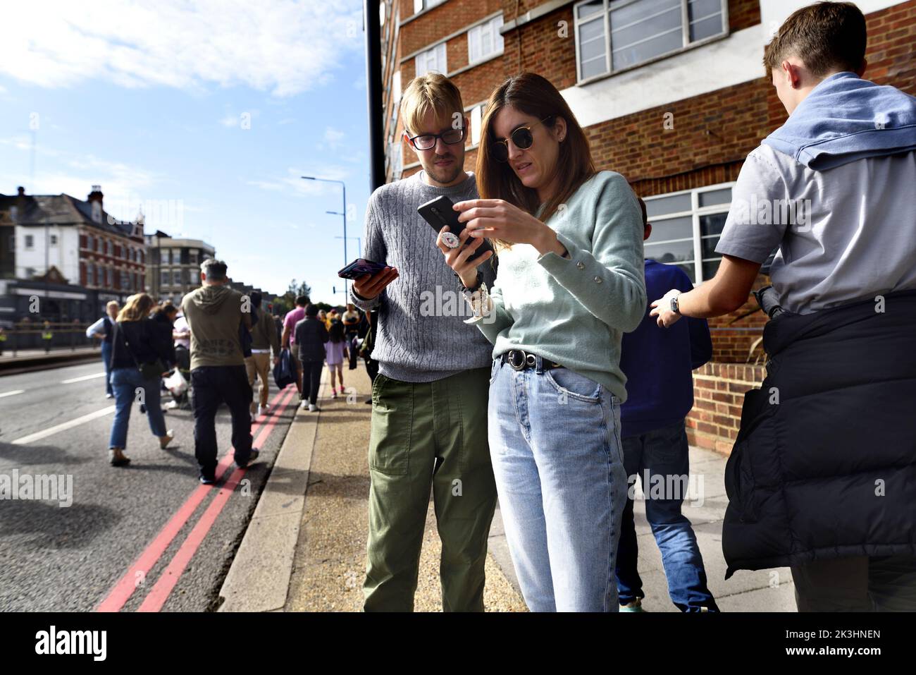 London, England, UK. Couple looking at their mobile phones Stock Photo