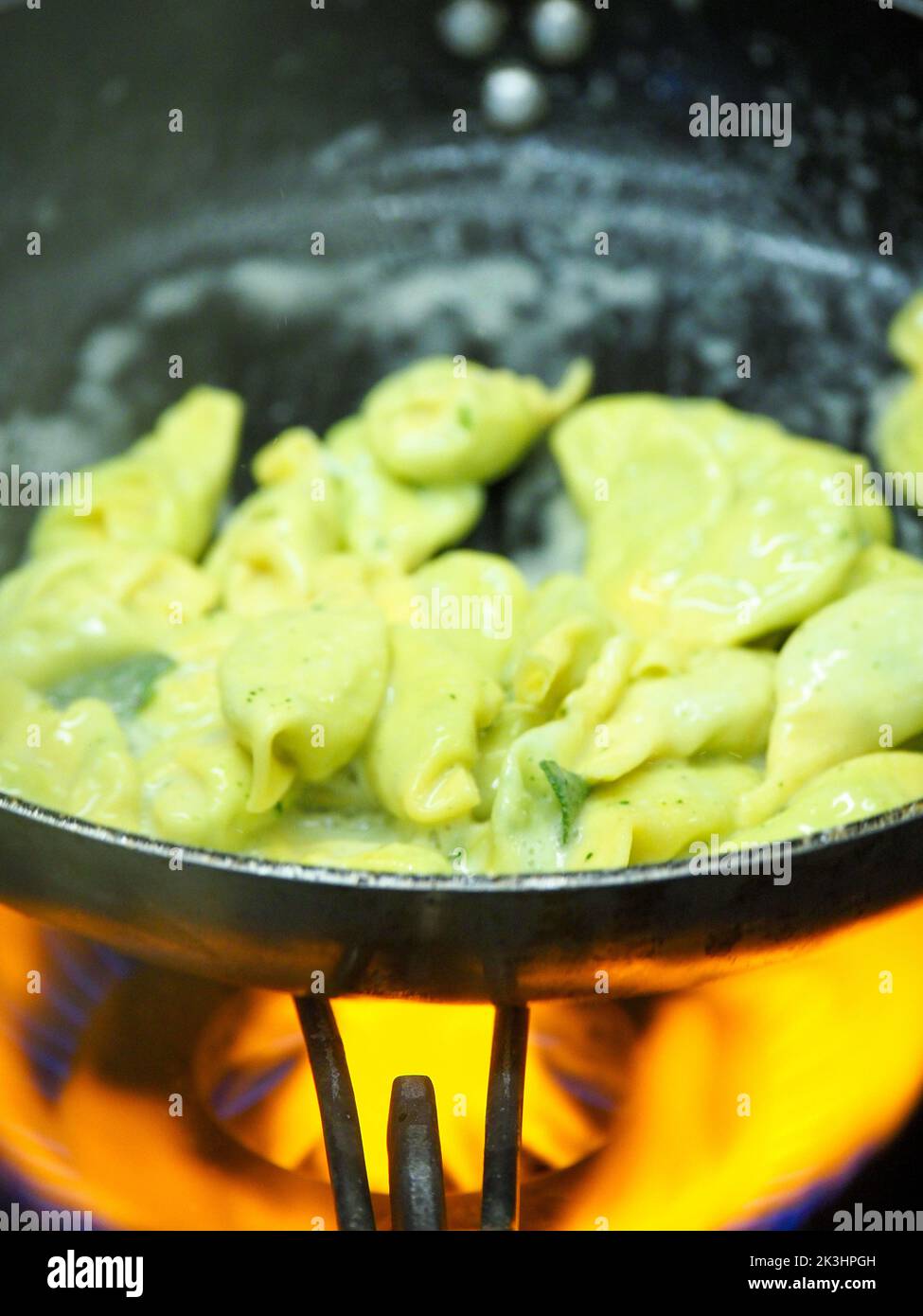 chef blending green ricotta cheese spinach filling tortellini Stock