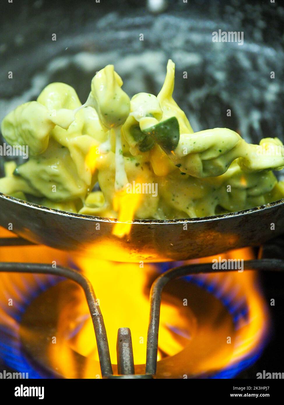chef blending green ricotta cheese spinach filling tortellini Stock