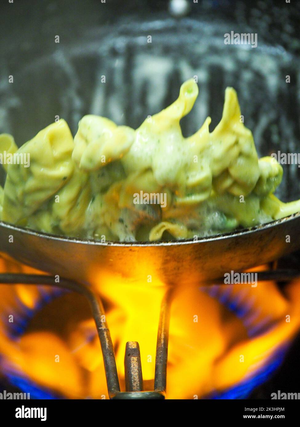chef blending green ricotta cheese spinach filling tortellini Stock