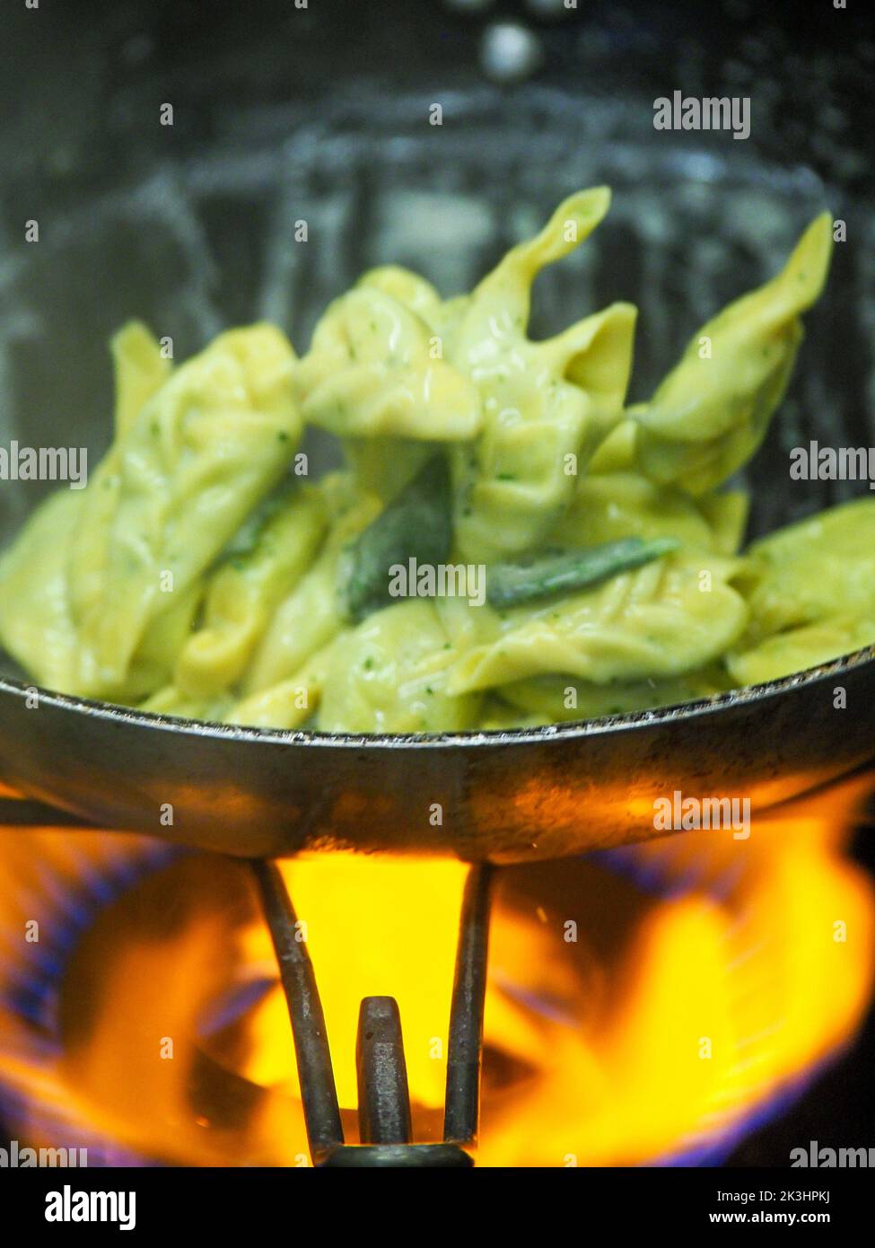 chef blending green ricotta cheese spinach filling tortellini Stock