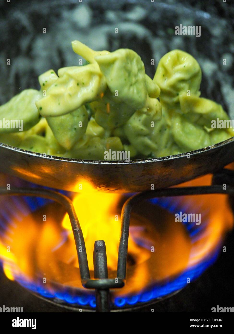 chef blending green ricotta cheese spinach filling tortellini Stock
