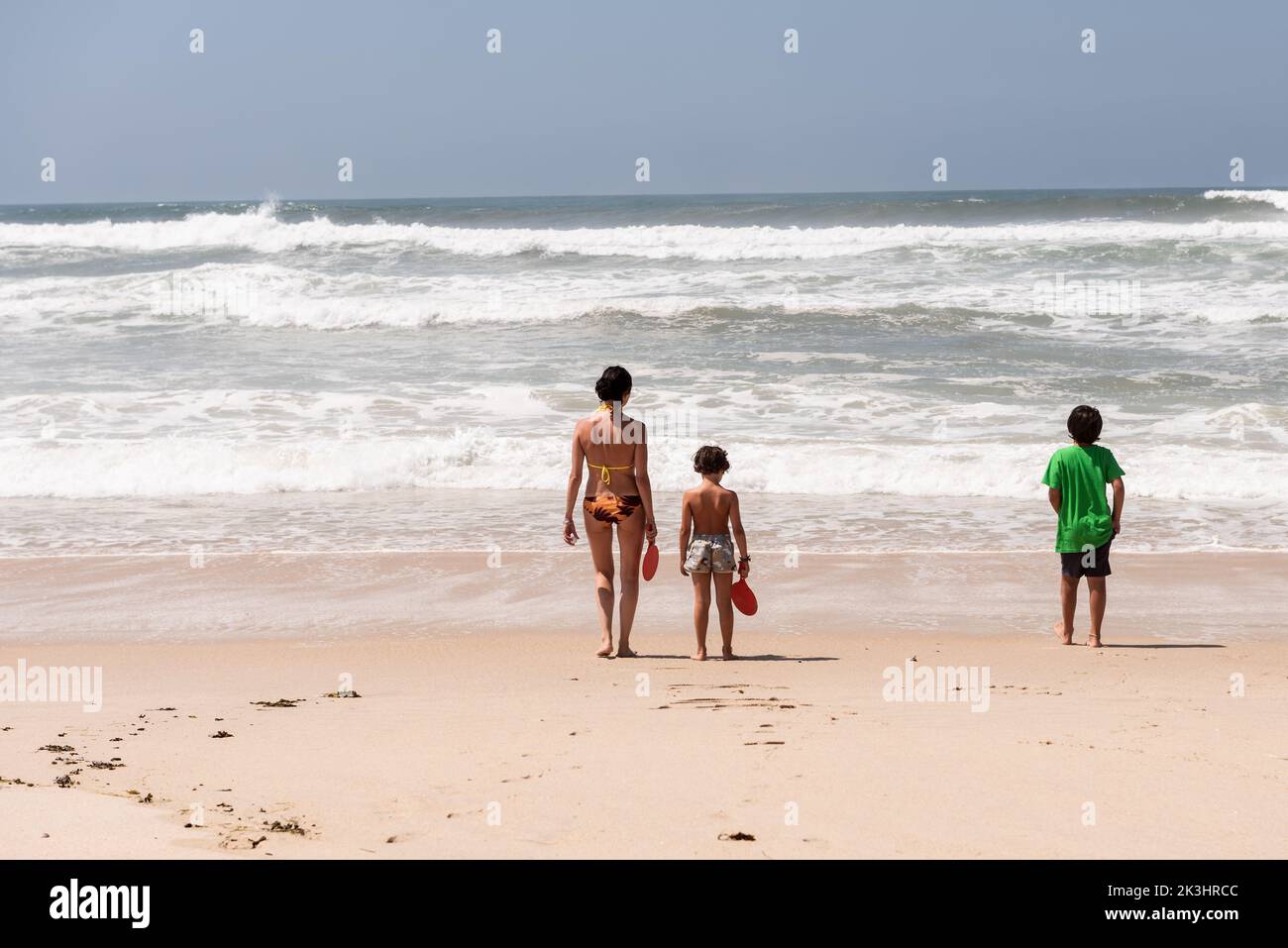 a woman and her children enjoy a day at the beach in aveiro Portugal Stock Photo