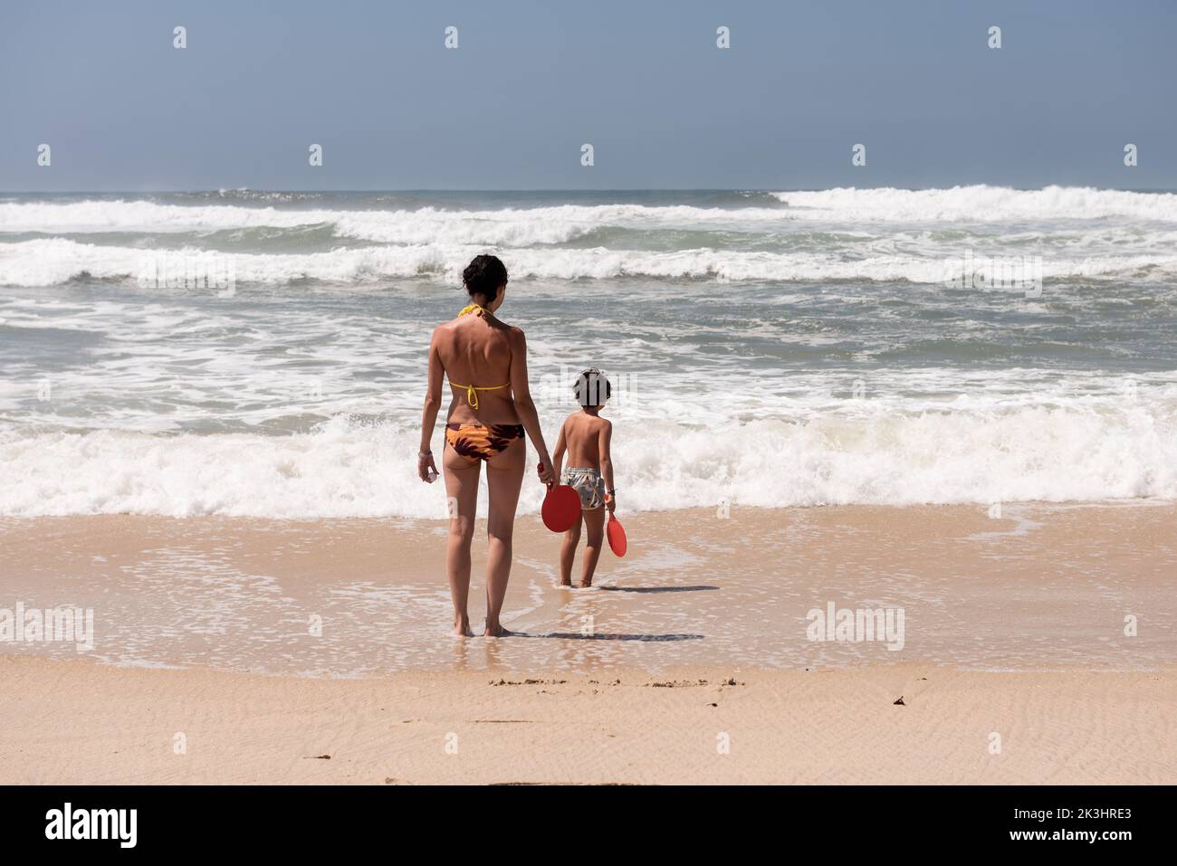 a woman and her children enjoy a day at the beach in aveiro Portugal Stock Photo