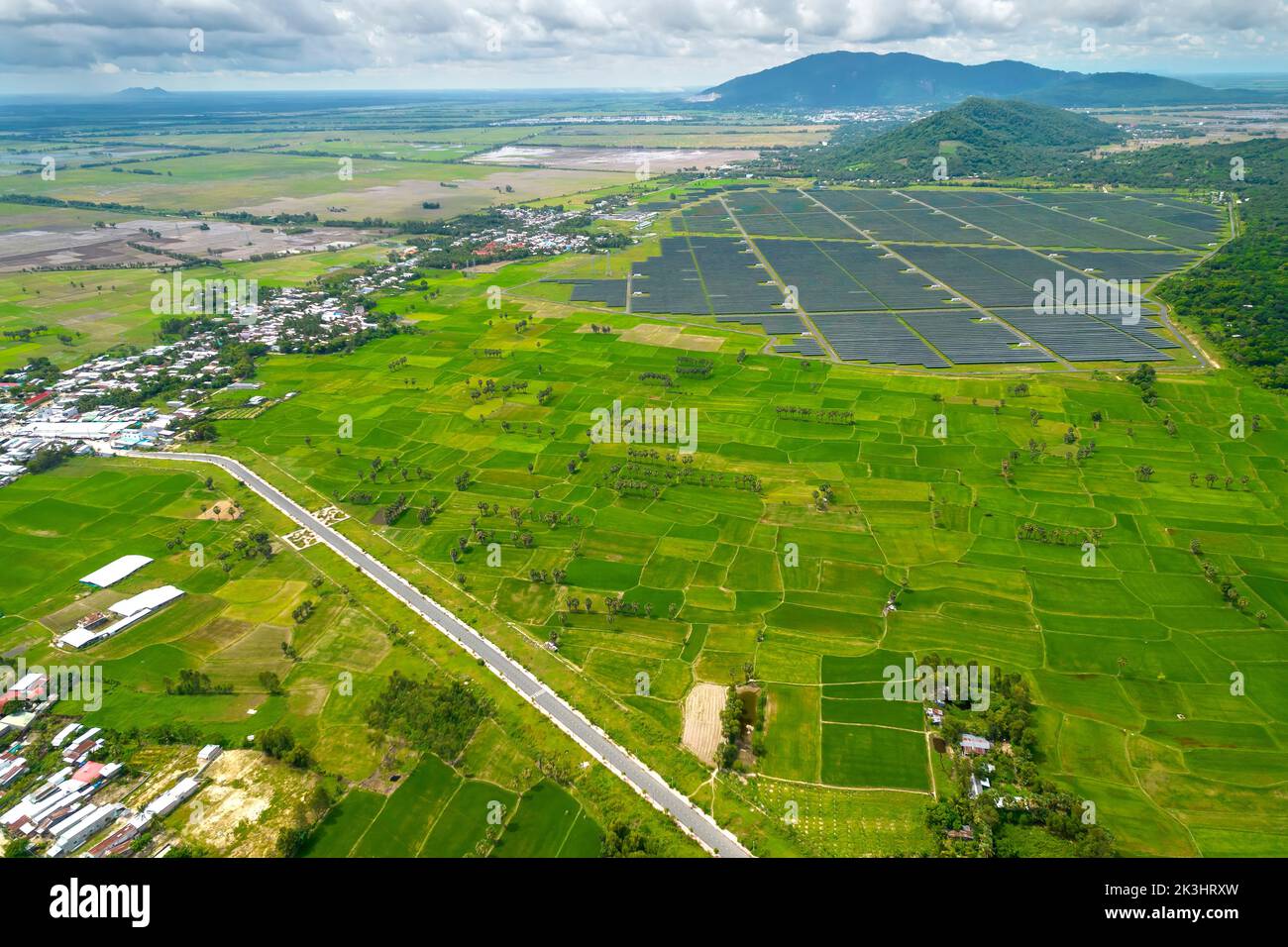 Rice fields interspersed with solar power fields in the morning, a combination of agriculture and energy industry in the border region of Vietnam Stock Photo