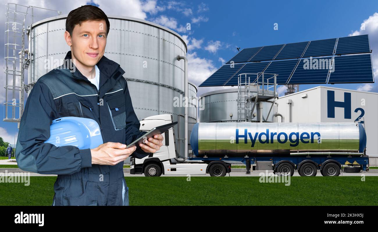 Engineer with tablet computer on a background of Hydrogen factory  Stock Photo
