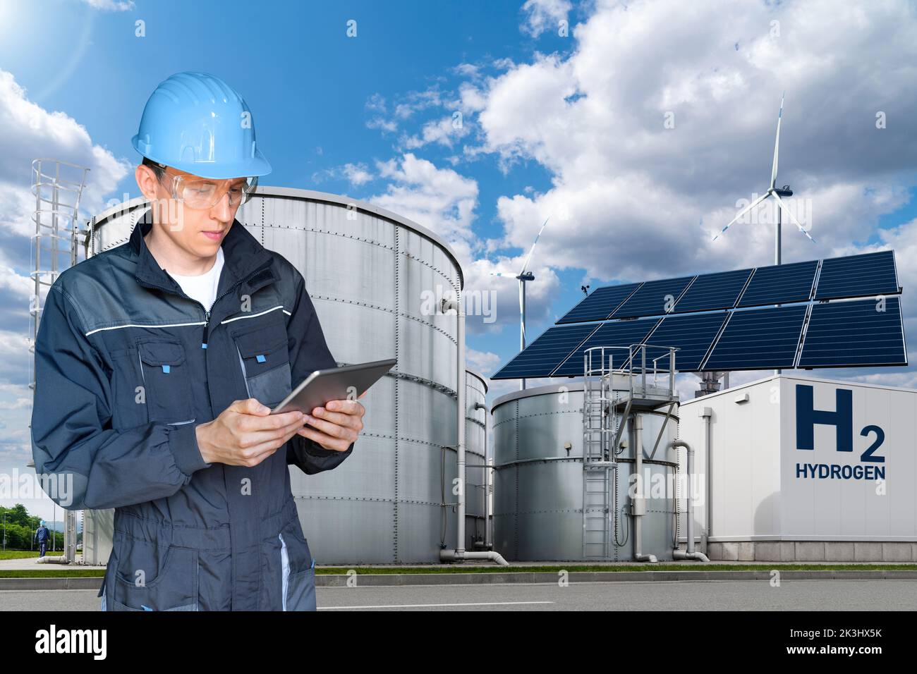 Engineer with tablet computer on a background of Hydrogen factory  Stock Photo