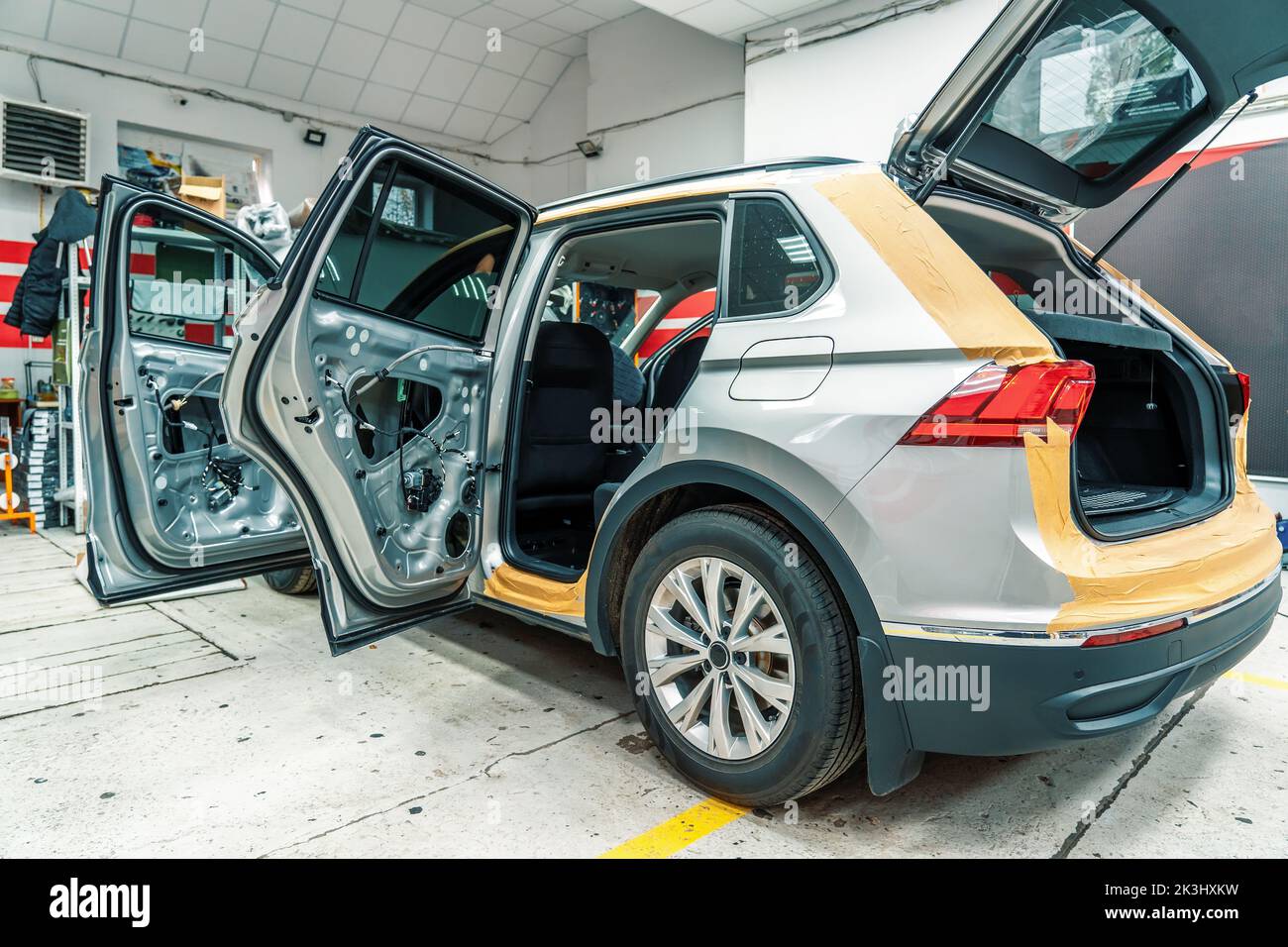 Car in process of installing noise insulation, disassembled doors