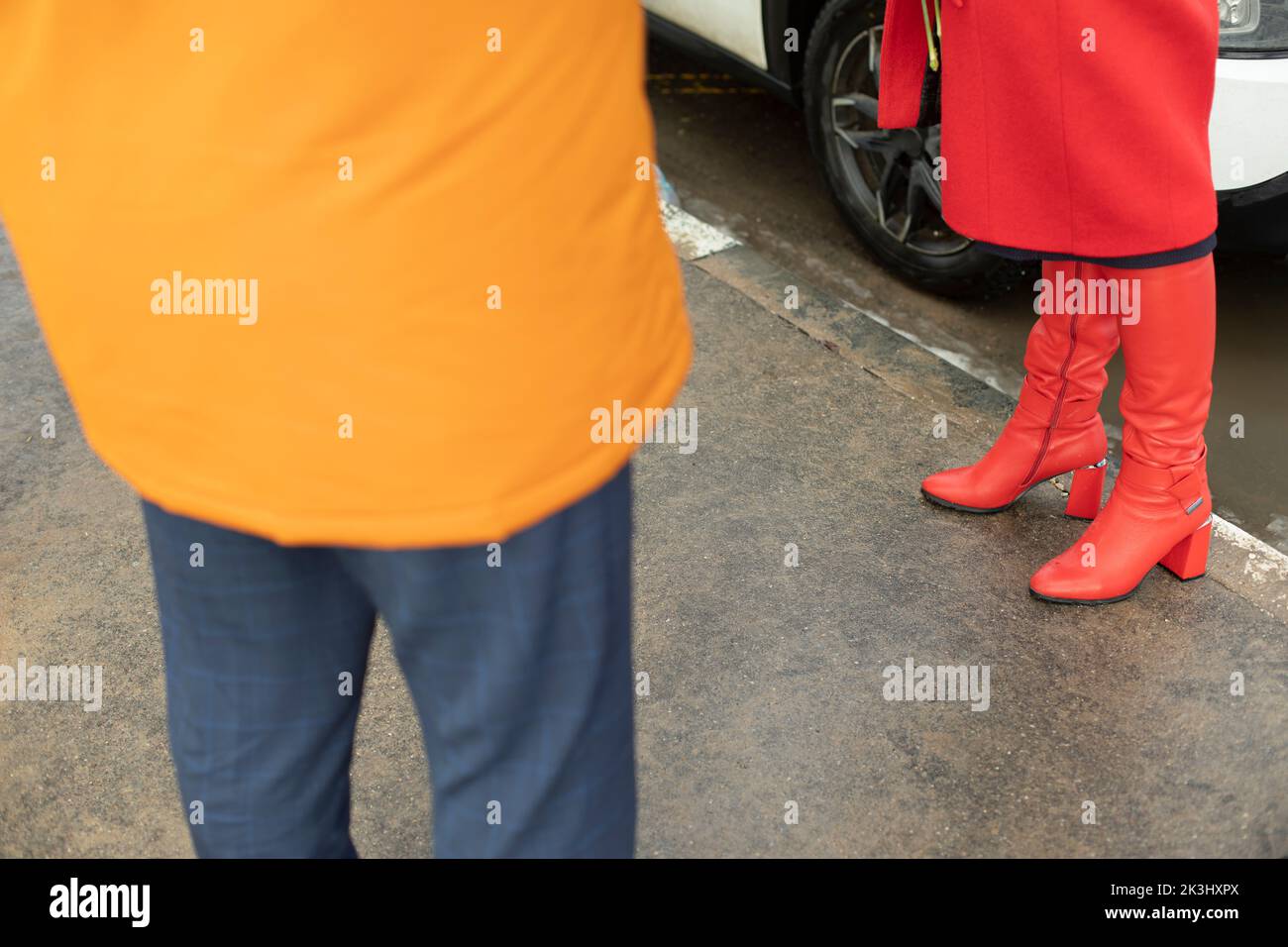 Red boots. Red women's clothing. Meeting people. Romantic mood. Stock Photo