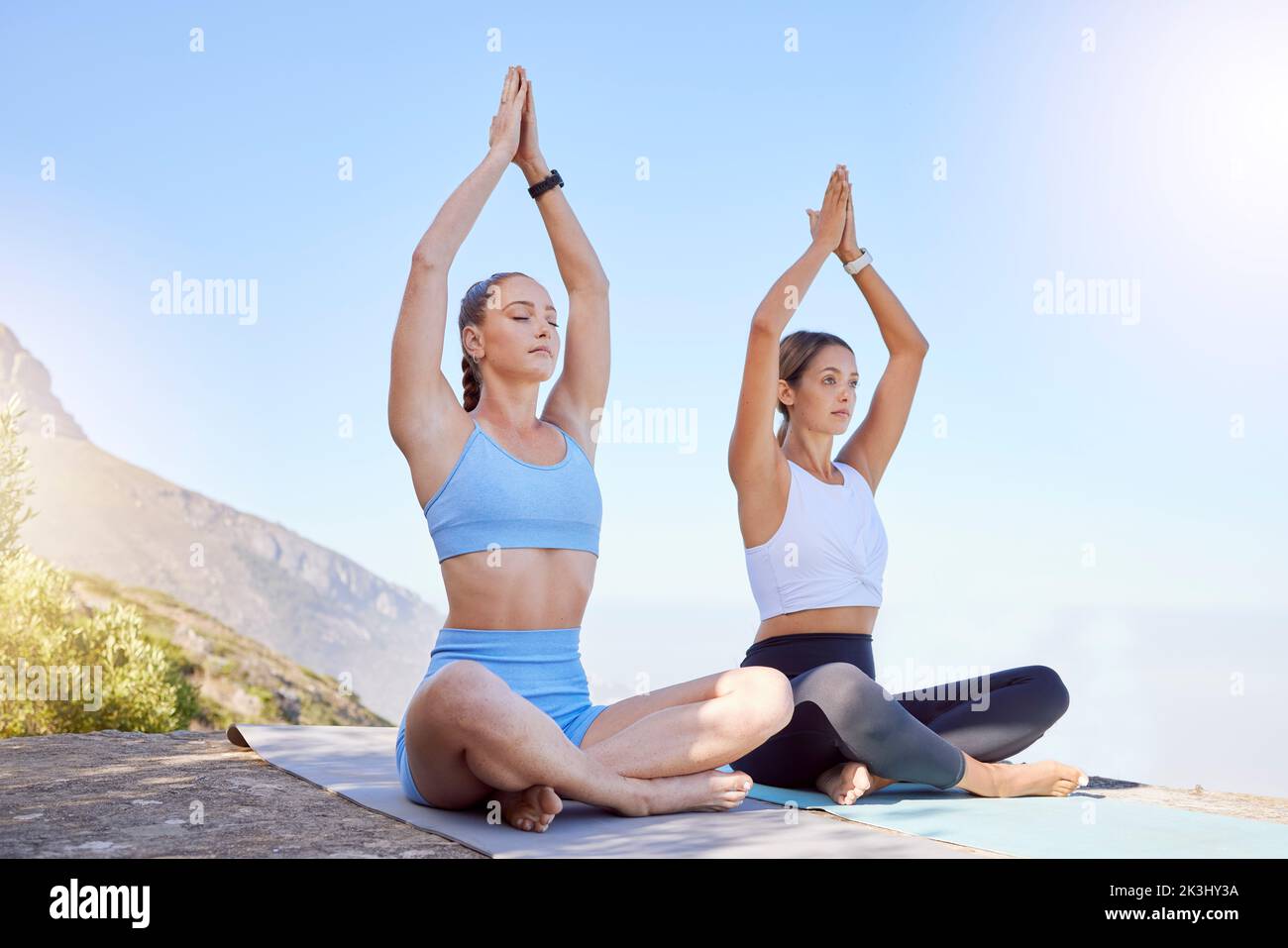 Women, meditation and zen yoga on mountains for chakra energy, mental health and relax mind training. Friends, people or yogi in peace workout Stock Photo