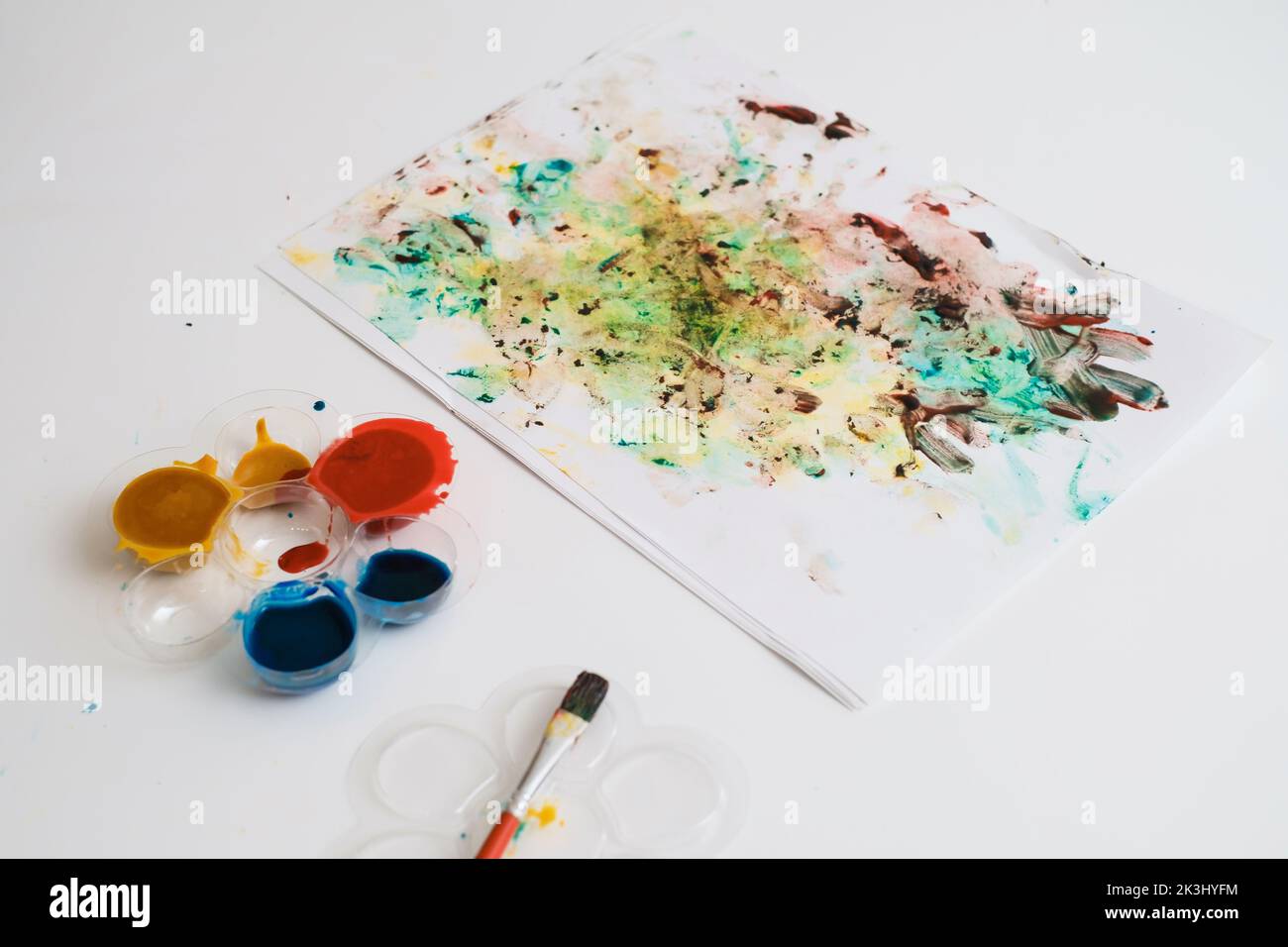 painting with fingers and hands of cerebral palsy child. close-up, handicap kid developing fine motor skills. sensory therapy game Education for Stock Photo