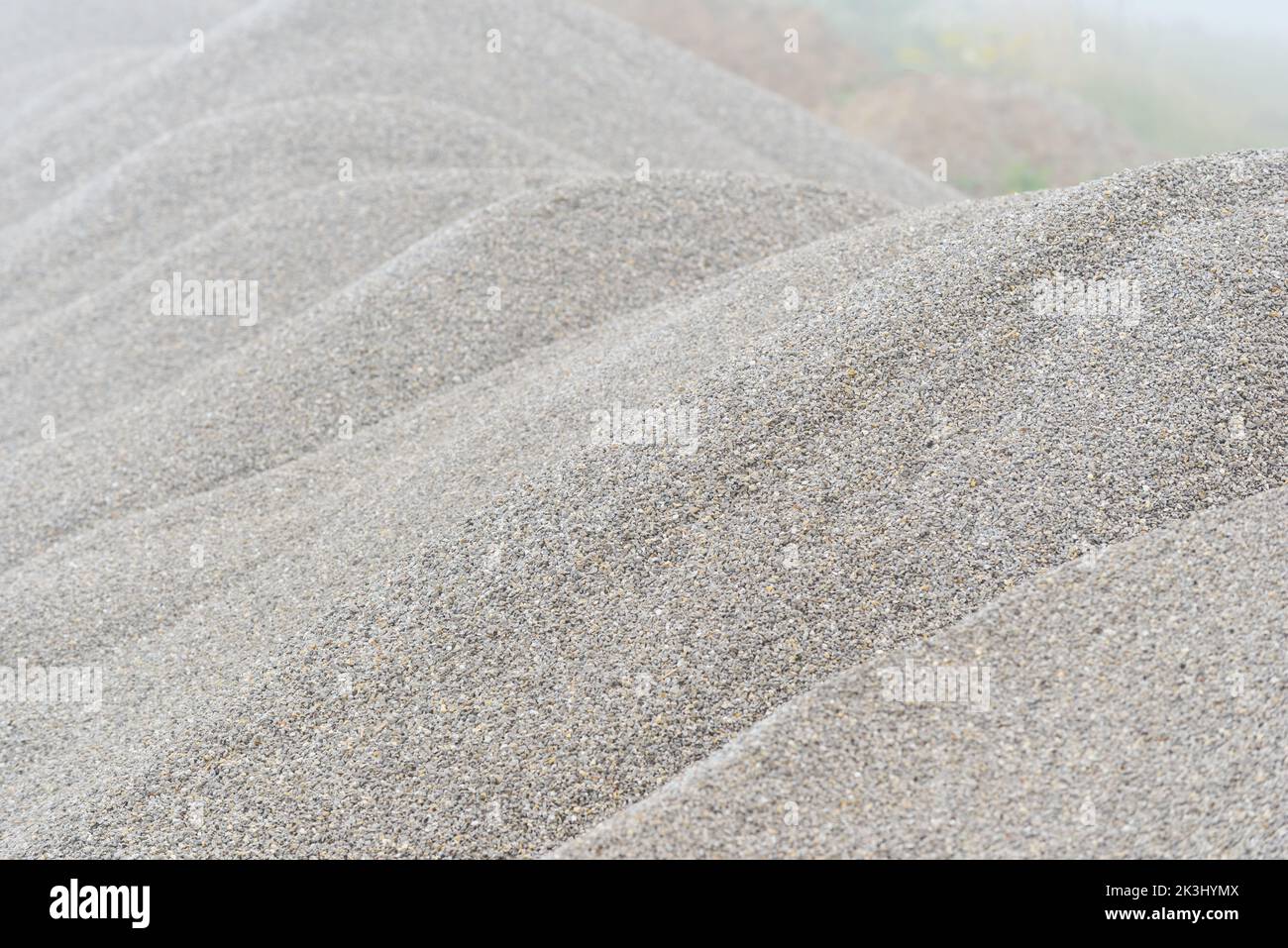 Large pile of gray gravel stone as road construction material as natural background, selective focus Stock Photo