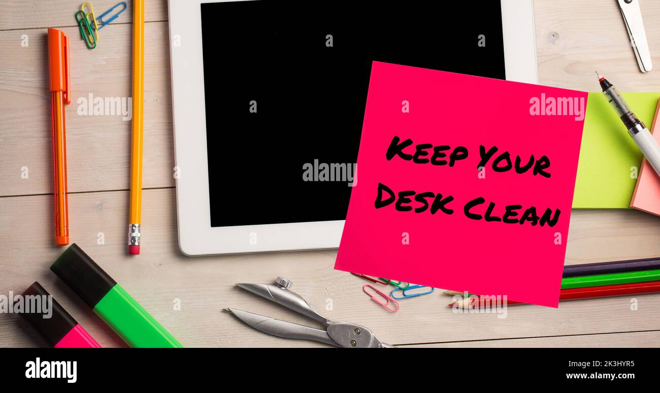 Composite of keep your desk clean text on sticky note with digital