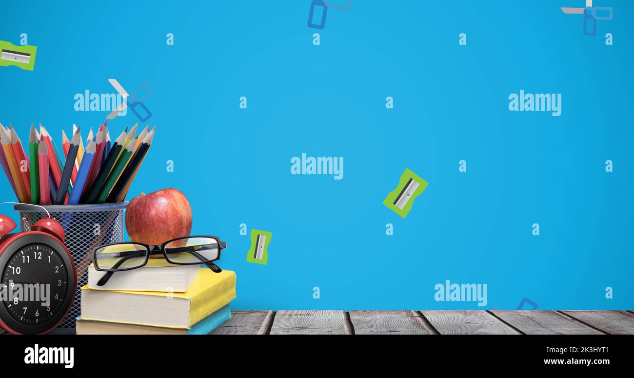 Composite of sharpeners and scissors falling on office supplies, apple ...
