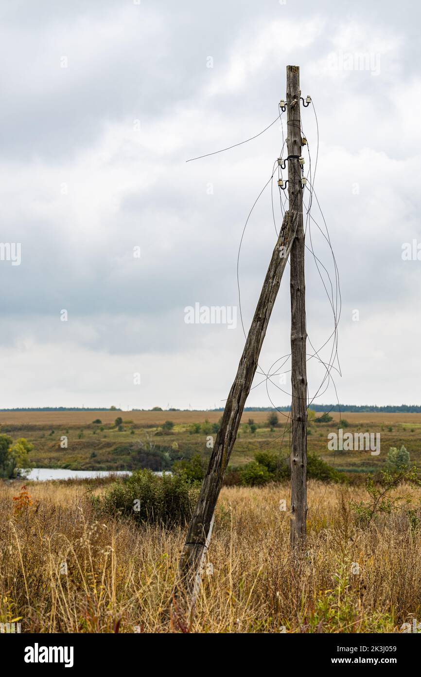 old power line pole with broken wires. broken wires Stock Photo - Alamy