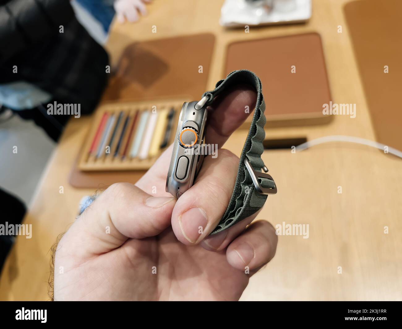 Paris, France - Sep 23, 2022: Man looking at the side of Apple Store first day of sale for new titanium Apple Watch Ultra designed for extreme activities like endurance sports, elite athletes, trailblazing, adventure Stock Photo