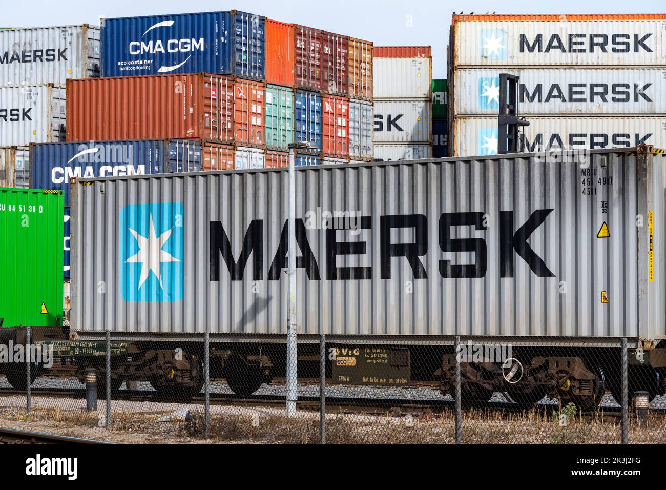 Maersk shipping container leaving the port of Felixstowe by rail Stock Photo