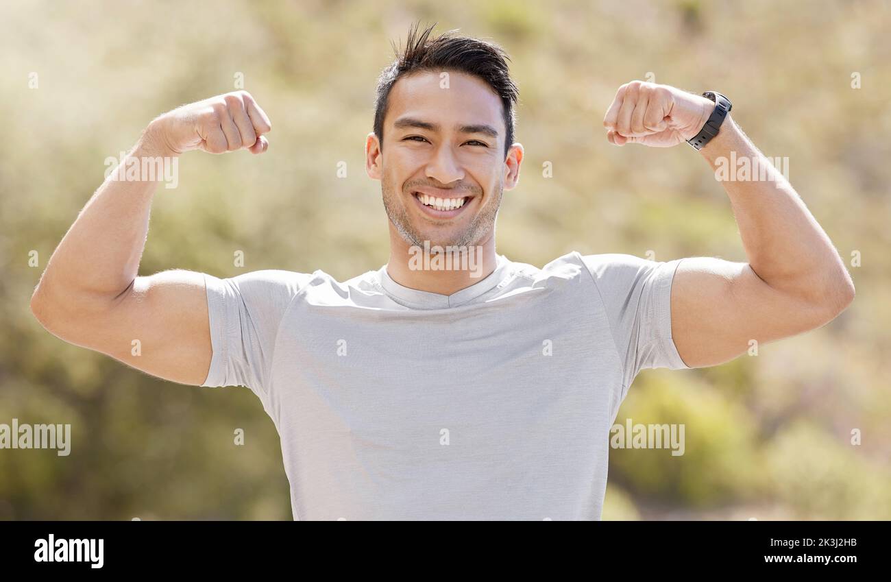 Sport, fitness and exercise with a flexing man showing his muscles and biceps while proud of his strong build. Workout, training and health with a Stock Photo