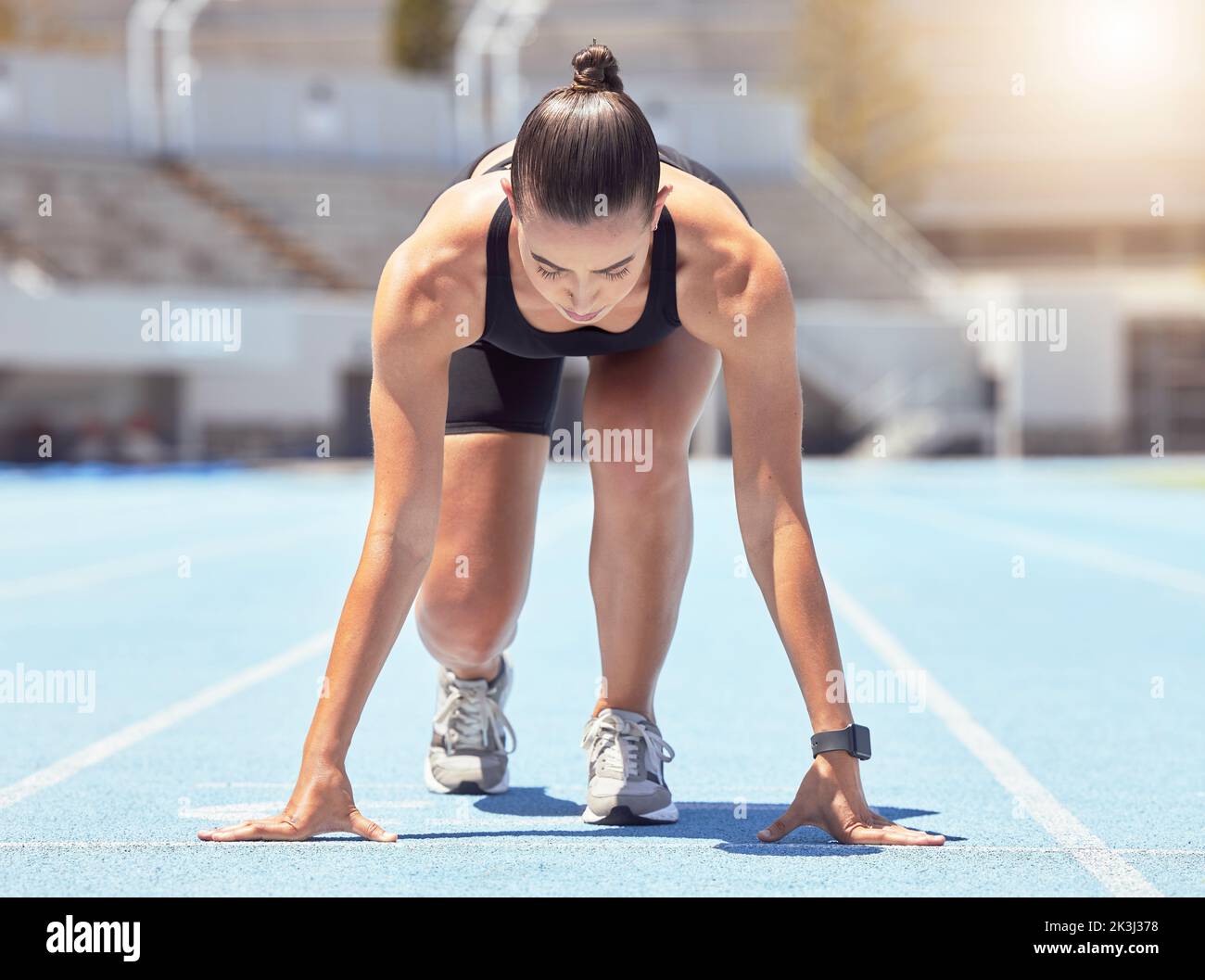 Motivation, energy and runner start training at outdoor track, ready to practice go. Health, power and fitness goal by professional woman athlete with Stock Photo