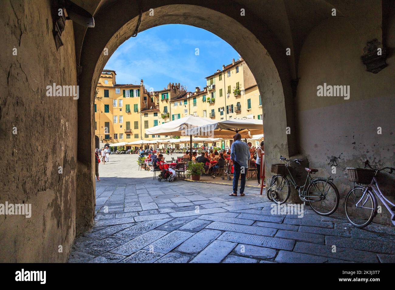 LUCCA, ITALY - SEPTEMBER 16, 2018: This is one of the arched passages to the Amphitheater Square. Stock Photo