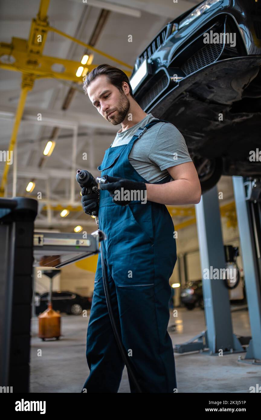 Car mechanic working in the auto repair shop Stock Photo