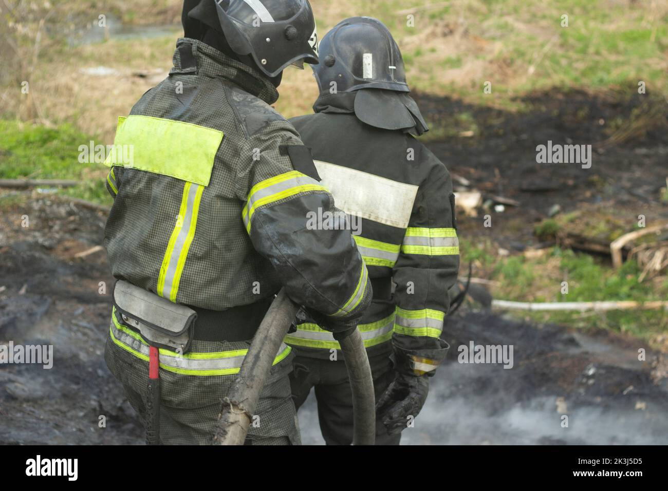 Lifeguard on duty. Firefighter puts out fire. Details of fire. Rescuer in Russia. Extinguishing fire in forest. Stock Photo