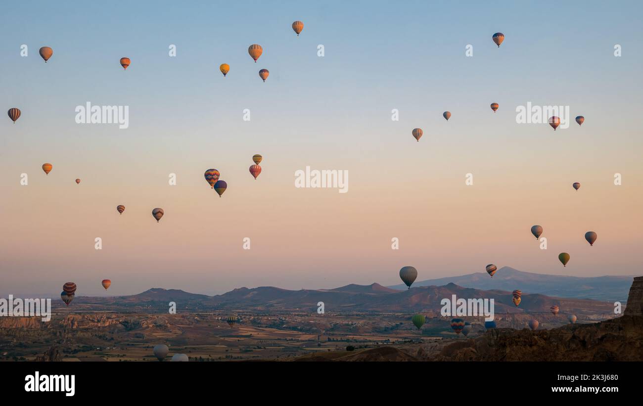 Background, Sunrise with hot air balloons in Cappadocia, Turkey balloons in Cappadocia Goreme Kapadokya, and Sunrise in the mountains of Cappadocia.  Stock Photo