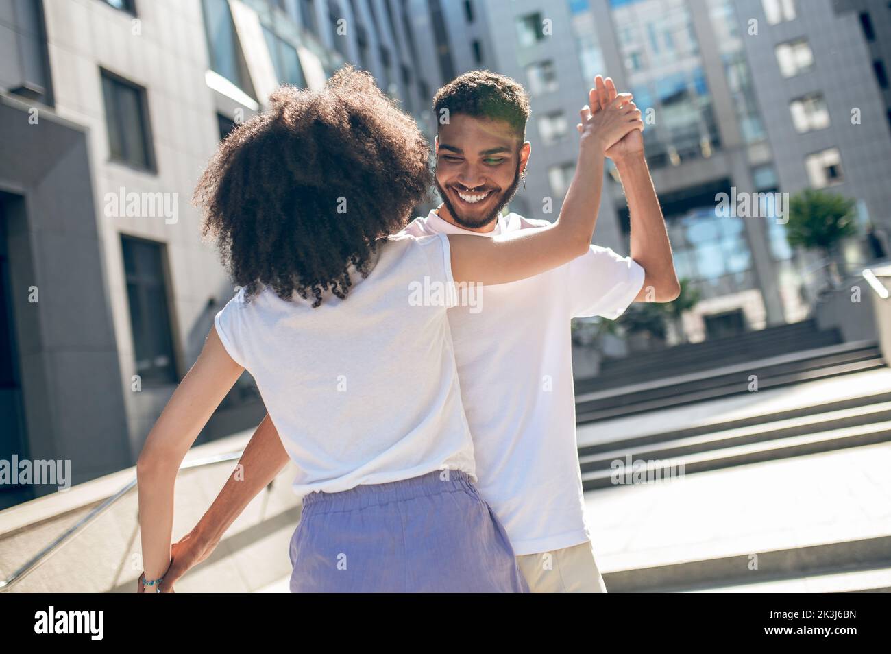 Happy cute young couple dancing in the street Stock Photo Alamy