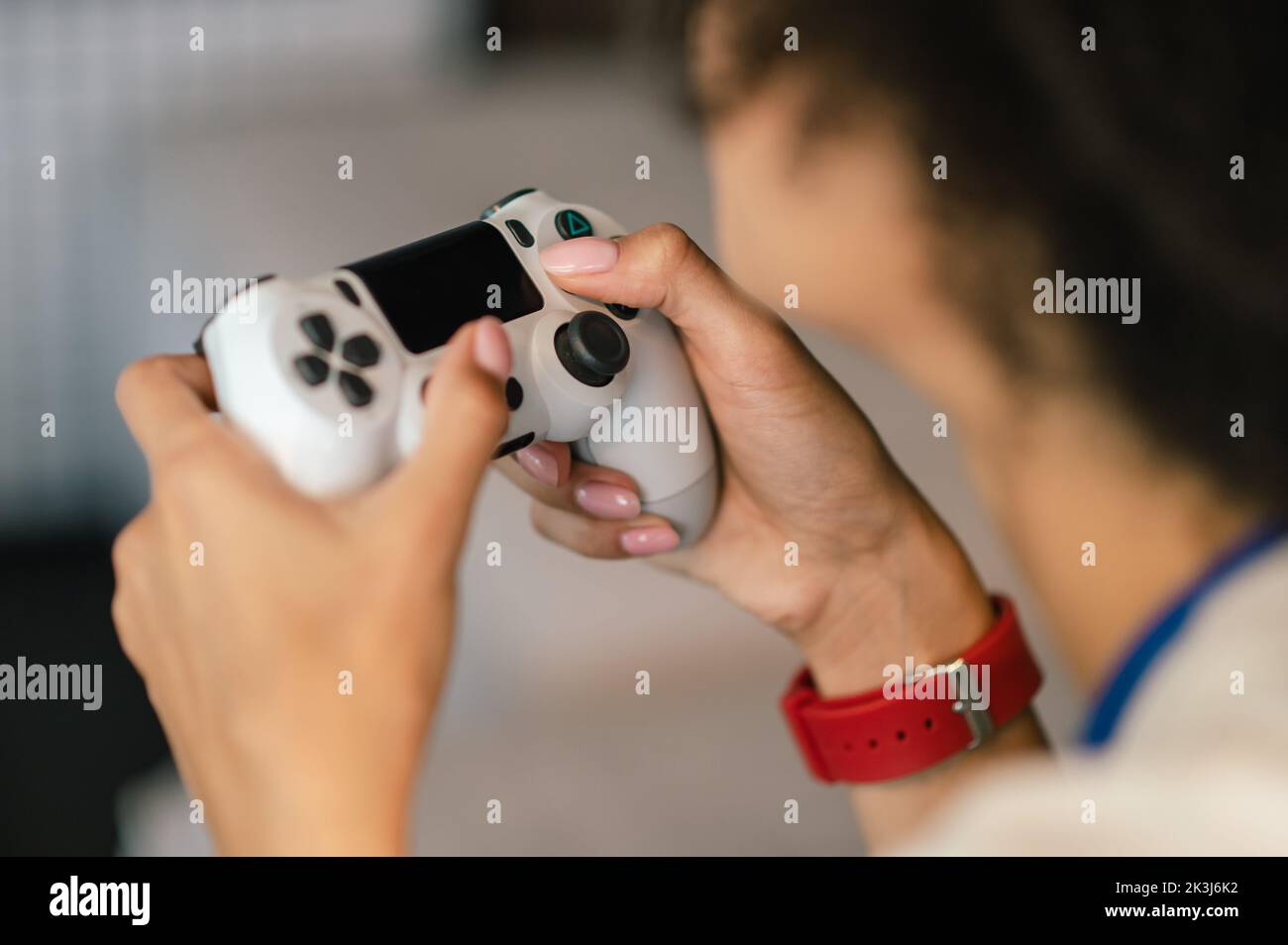 Young girl in white tshirt playong on playstation Stock Photo