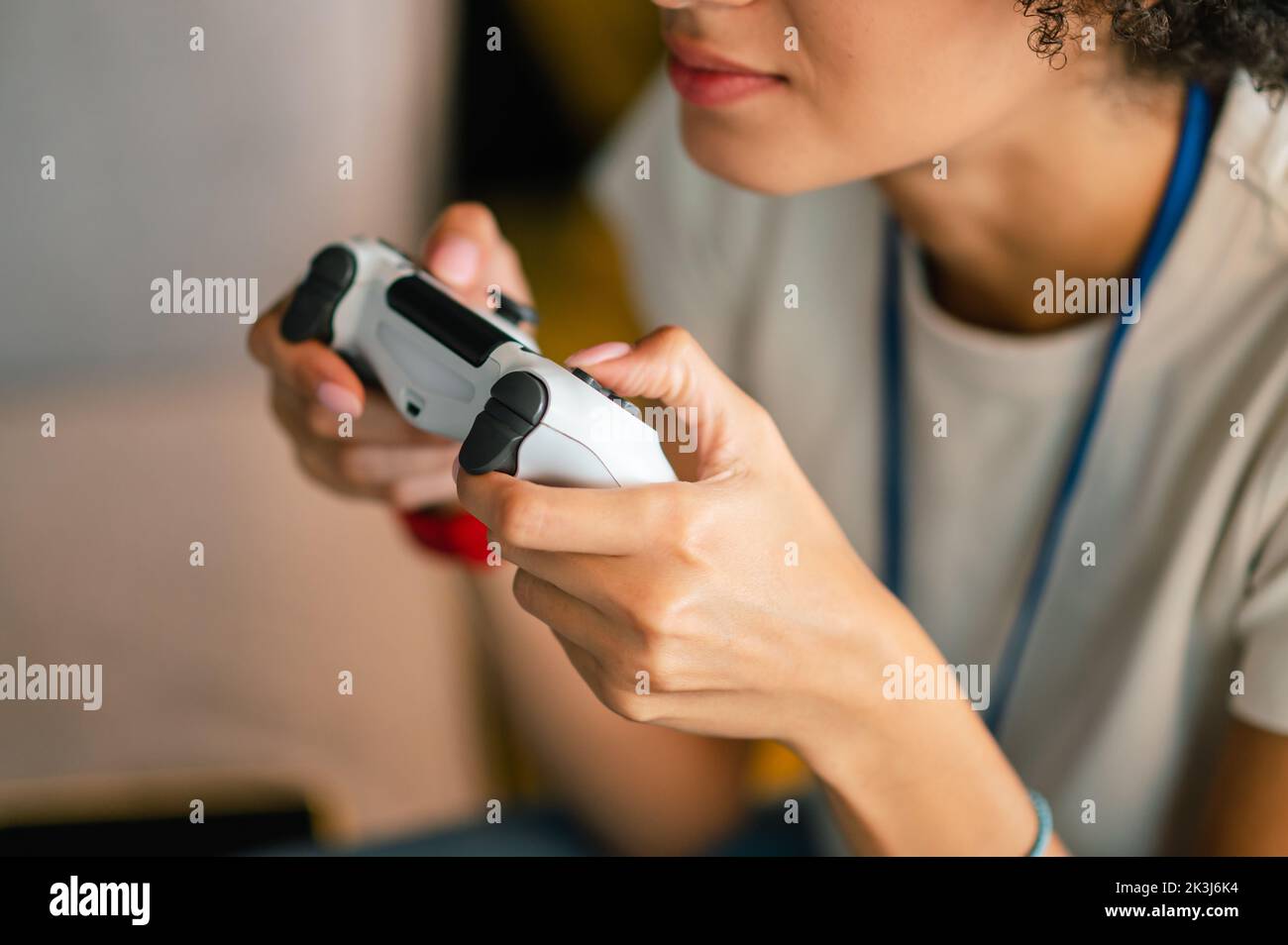 Young girl in white tshirt playong on playstation Stock Photo