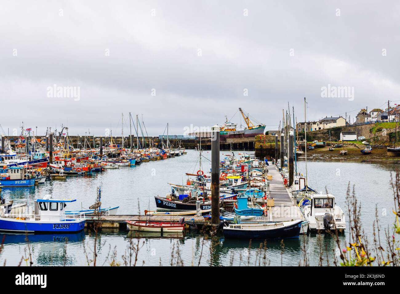 Fishing boats moored in the harbour at Newlyn, a small commercial fishing village in the West Country, on the south coast of west Cornwall, England Stock Photo