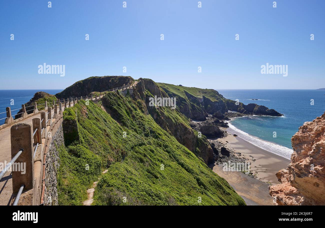 La Coupée, a narrow isthmus which connects Greater Sark to Little Sark, Sark, Channel Islands in early summer day with view of La Grande Greve beach Stock Photo