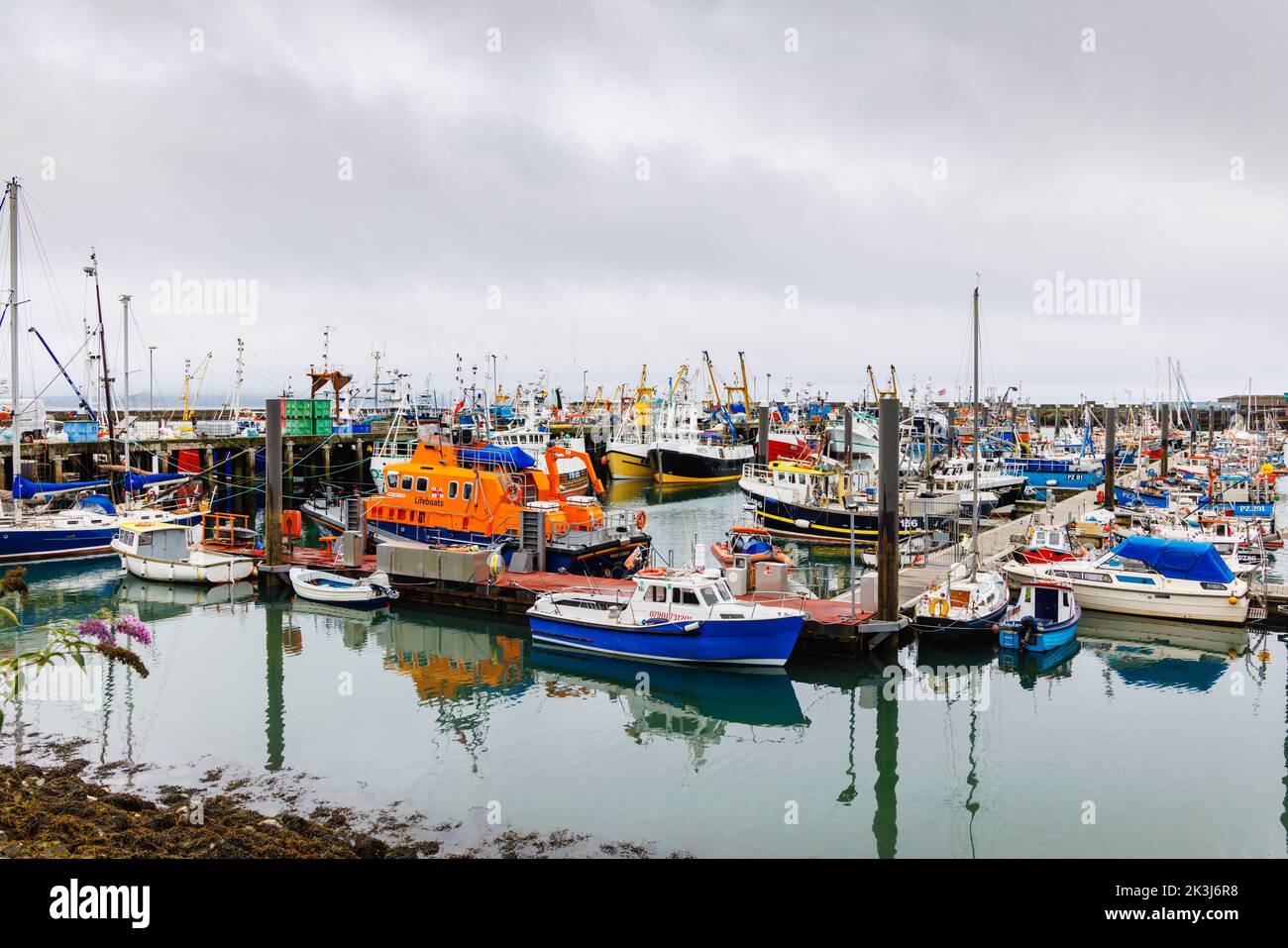 Fishing boats moored in the harbour at Newlyn, a small commercial fishing village in the West Country, on the south coast of west Cornwall, England Stock Photo