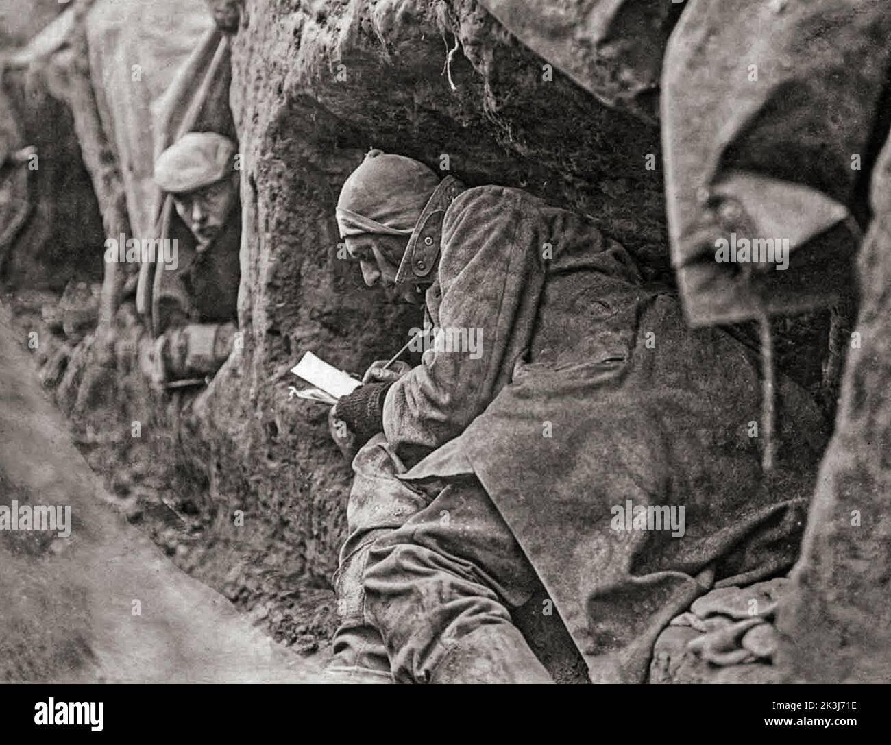 Soldiers in trenches during the First World War write letters home. Life in the trenches was summed up by the phrase which later became well-known: “Months of boredom punctuated by moments of extreme terror.” Stock Photo