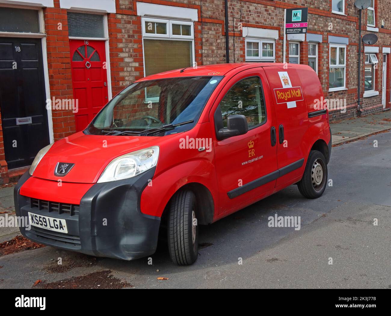 Red Royal Mail, post postal delivery van, in a Stockton Heath terraced street, South Warrington, Cheshire, England, UK, WA4 6NW Stock Photo