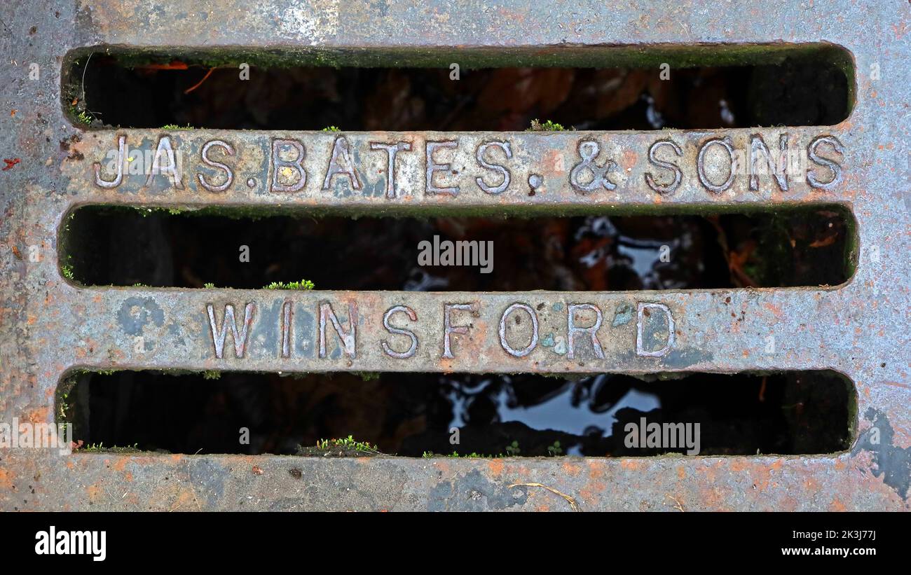 Cast Iron grid, embossed with JAS Bates & Sons, Winsford, Cheshire, England, UK, CW7 1AD - Essential for efficient urban road drainage for downpours Stock Photo
