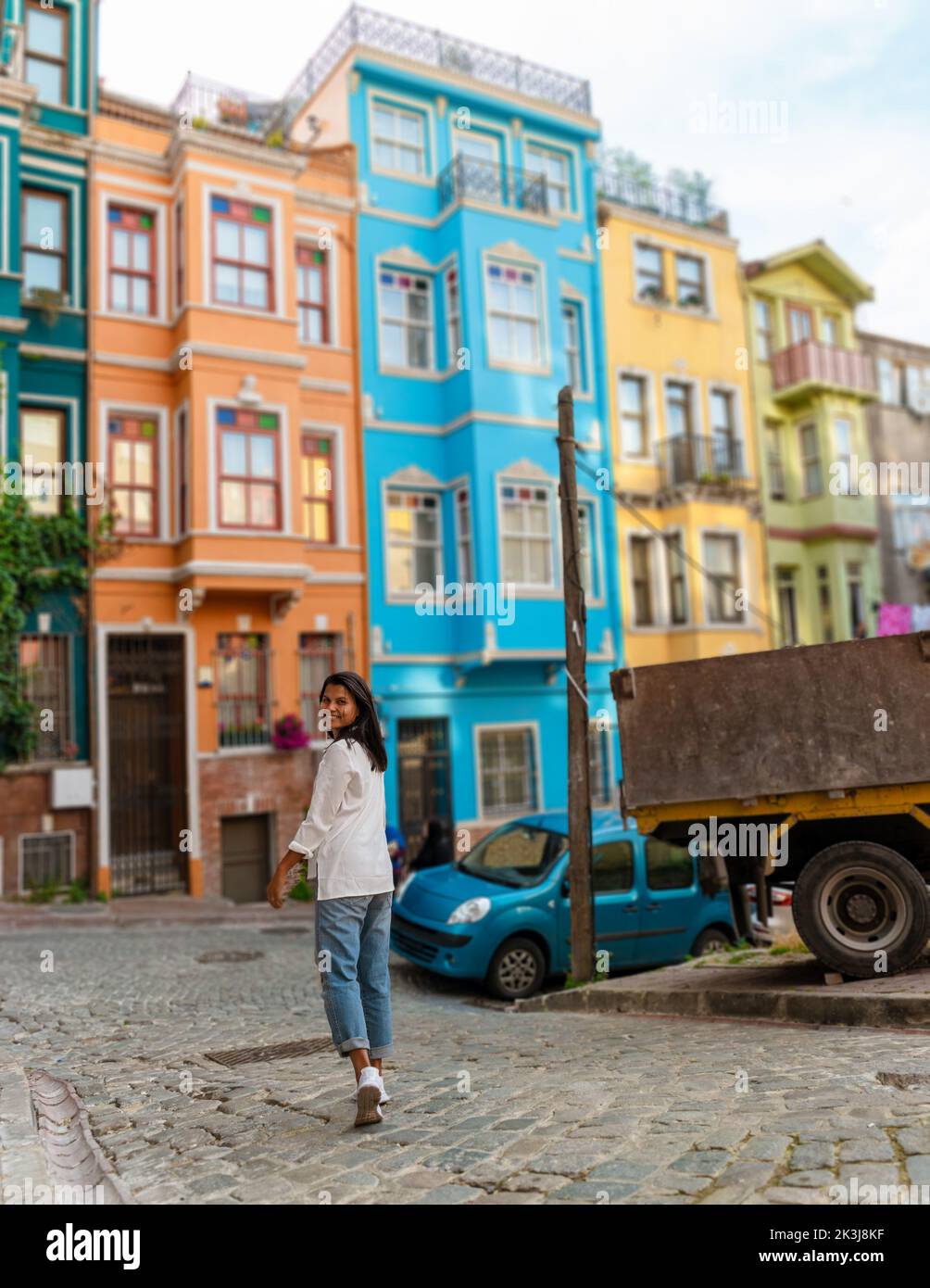 Asian women on city trip Balat district Istanbul Turkey, colorful homes and houses in the town of Balat with tourists enjoying a beautiful summer day.  Stock Photo