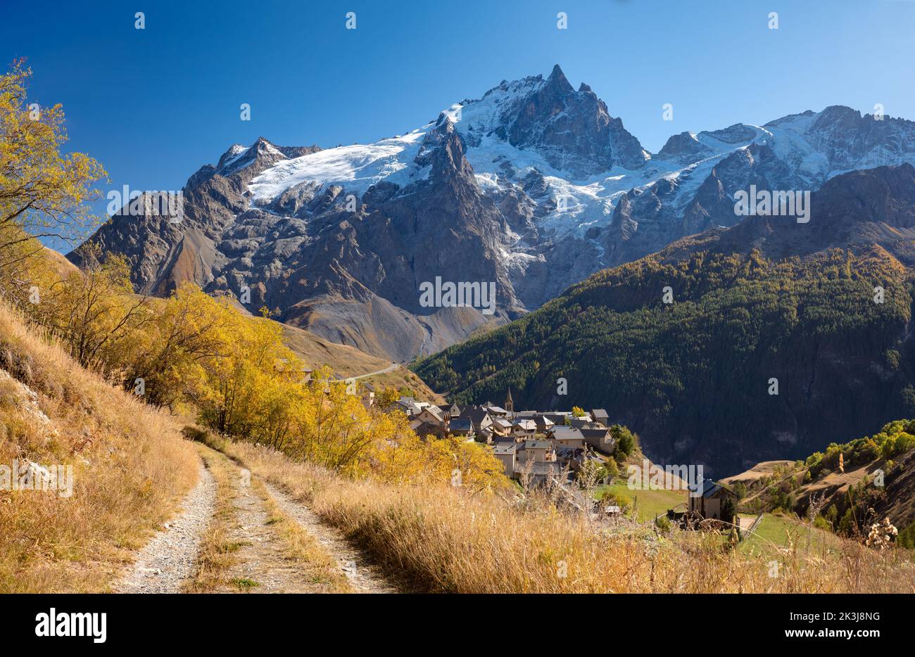 Ecrins National Park Massif with the village of Chazelet facing La Meije peak and glacier in autumn. Hautes-Alpes (French Alps). France Stock Photo
