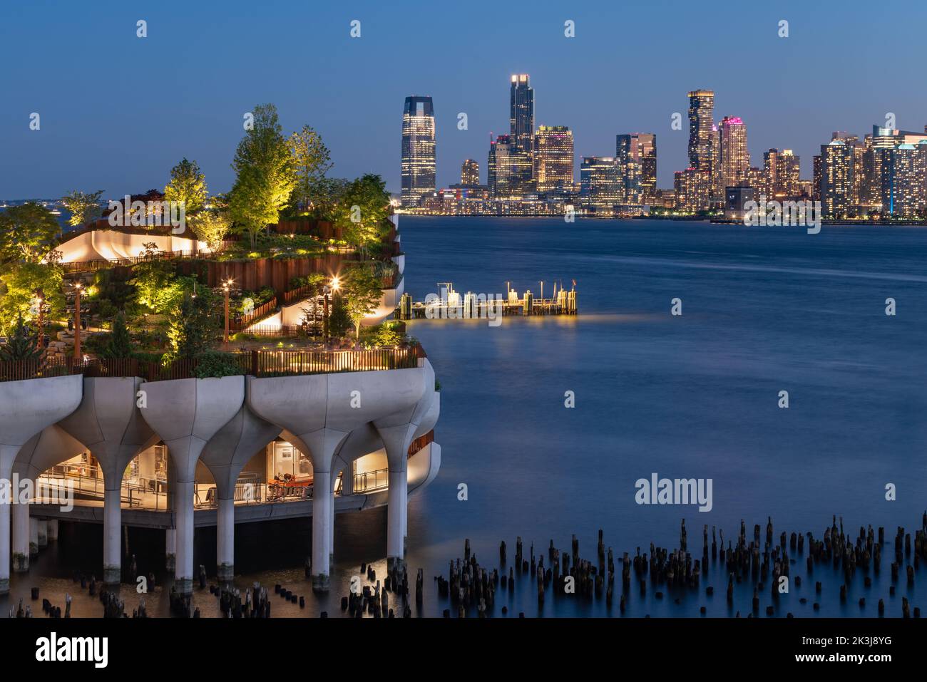 New York City, Little Island public park in evening with view of Downtown Jersey City. Elevated park at Hudson River Park, West Village, Manhattan Stock Photo