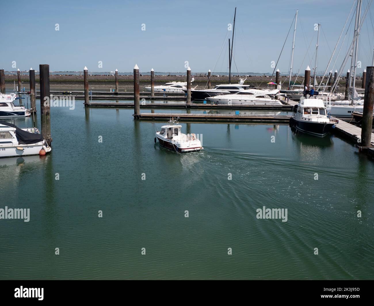 Breskens, Netherlands, July 18, 2022, Small pleasure boat sails from the harbor of Breskens Stock Photo
