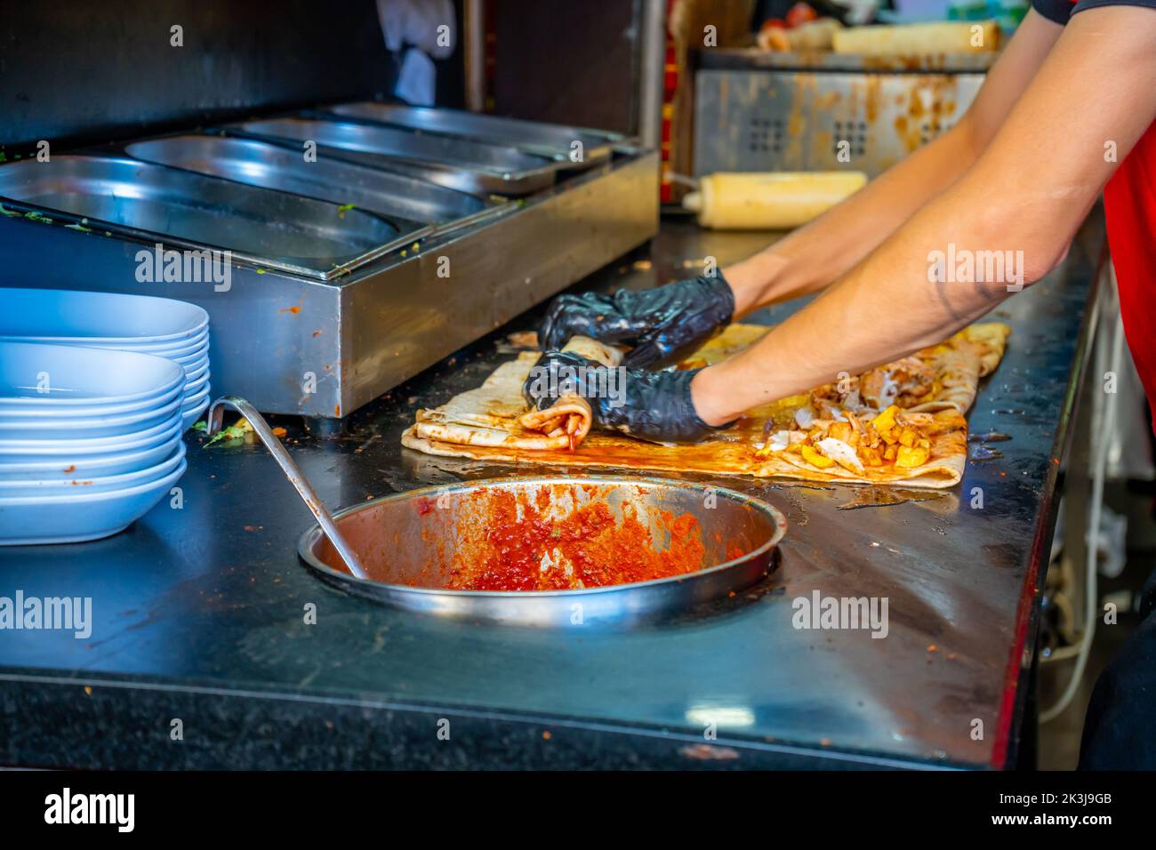 Turkish street food. Man bakes traditional griddlecake in old town
