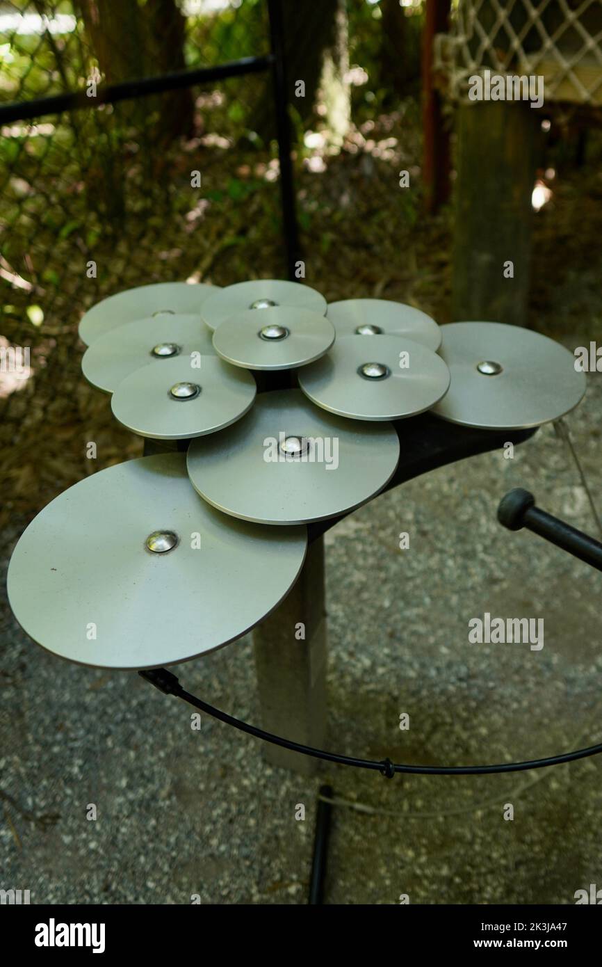 A vertical closeup shot of steel drum decorations in a park Stock Photo