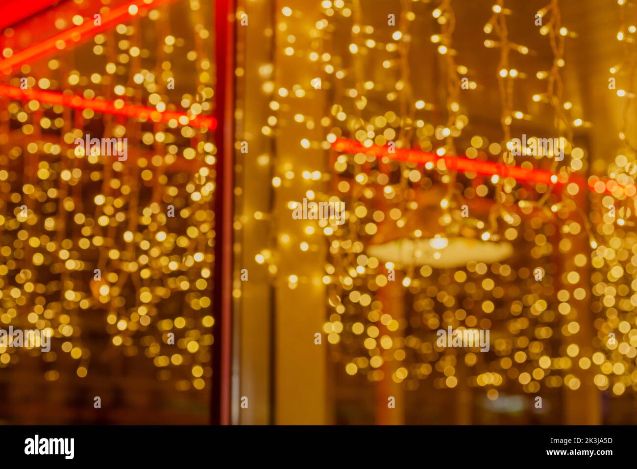 abstract golden bokeh lights in window of cafe Stock Photo