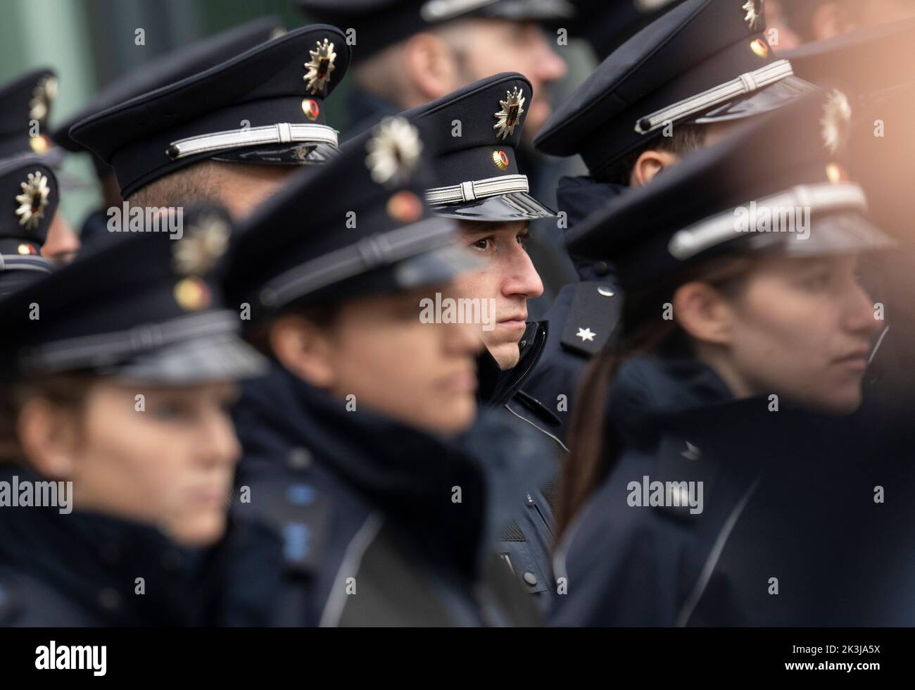 27 September 2022, Hessen, Frankfurt/Main: Young officers of the Federal Police watch a speech at their swearing-in ceremony at the Federal Police Headquarters at Frankfurt Airport. At the swearing-in ceremonies, which take place every six months, the young officers are officially sworn into service. Photo: Boris Roessler/dpa Stock Photo